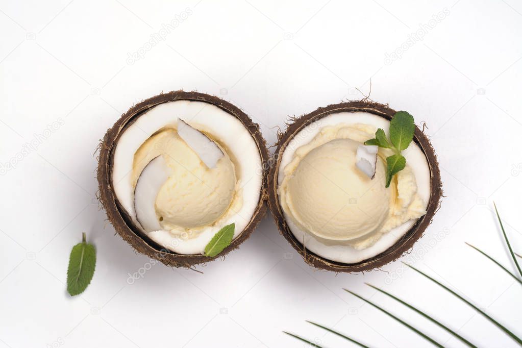 Coconut ice cream scoops in halves of coconut shell