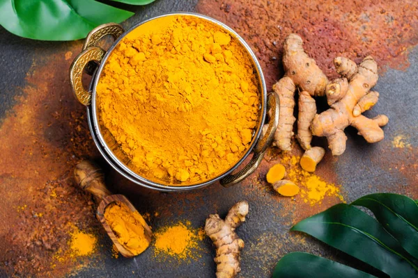 Turmeric powder and fresh root on grunge background — Stock Photo, Image