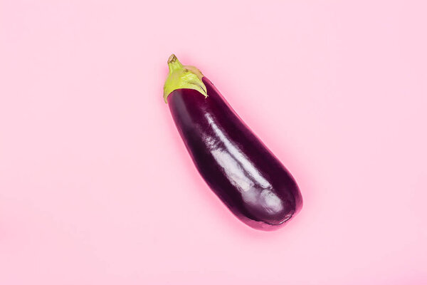 Fresh eggplant on pink background