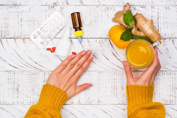 Womans hands holding turmeric drink — Stock Photo, Image