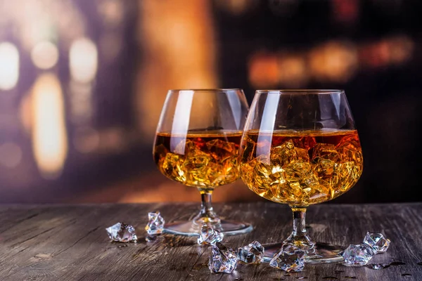 Two glasses of Cognac with ice cubes — Stock Photo, Image