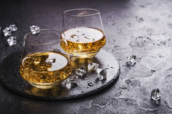 Two glasses of Cognac with ice cubes — Stock Photo, Image
