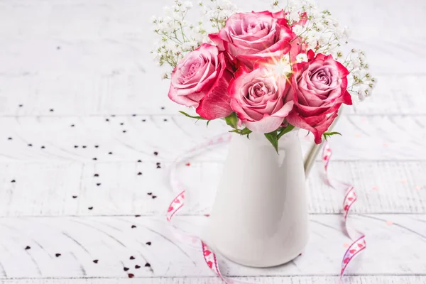 白色水罐中的粉红色玫瑰 — 图库照片