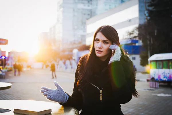 Portrait of angry woman talking on the phone at city centre