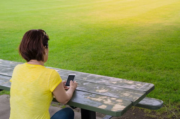 Mujer Usando Teléfono Móvil Mientras Está Sentada Aire Libre — Foto de Stock