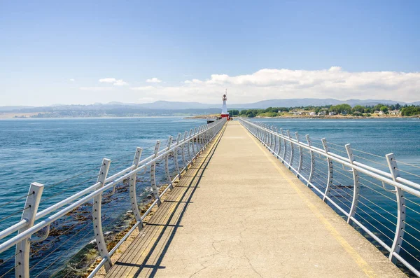 Lighthouse at the End of a Breakwater on a Clear Summer Day. Victoria, BC, Canada.