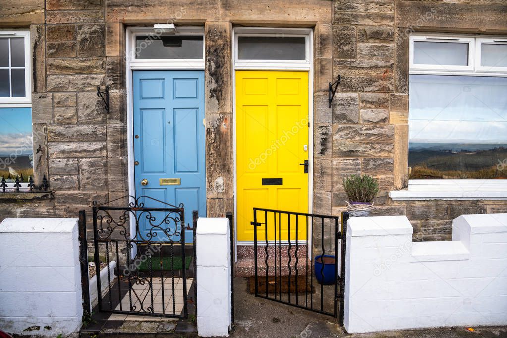 Colourful Wooden Front Doors of two Old British Stone Terraced Houses. Musselburgh, Scotland, UK.