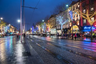 Dublin, Ireland - December 8, 2018: Shoppers and Tourists in O'Connell Street Decorated for Christmas. OConnell Street, Dublin's main thoroughfare, is effectively the center of Dublin and the home of the 