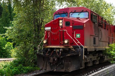 Photo of Poerful Diesel Locomotive Pulling a Freight Train on a Sunny Summer Day. British Columbia, Canada. clipart