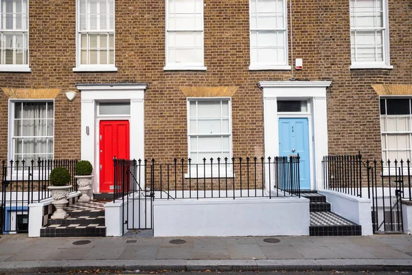 Traditional British Brick Terraced Houses with Colourful Wooden Doors