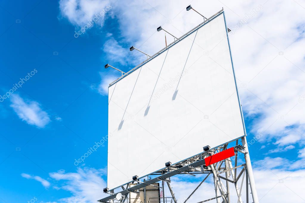 Big Blank Rooftop Billboard against Blue Sky with Clouds. Copy Space.