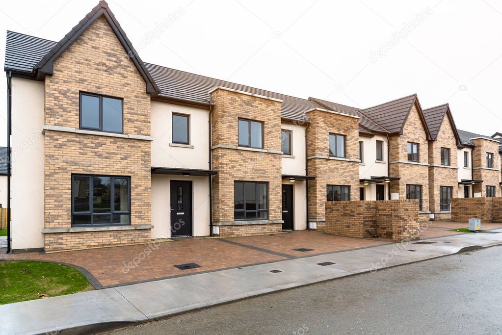 New Houses for sale in a housing estate in Ireland on wet winter day