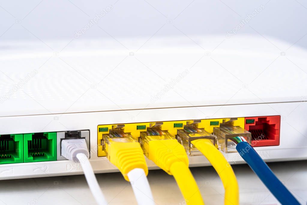 Close up of the back of a modem router with colourful network cables