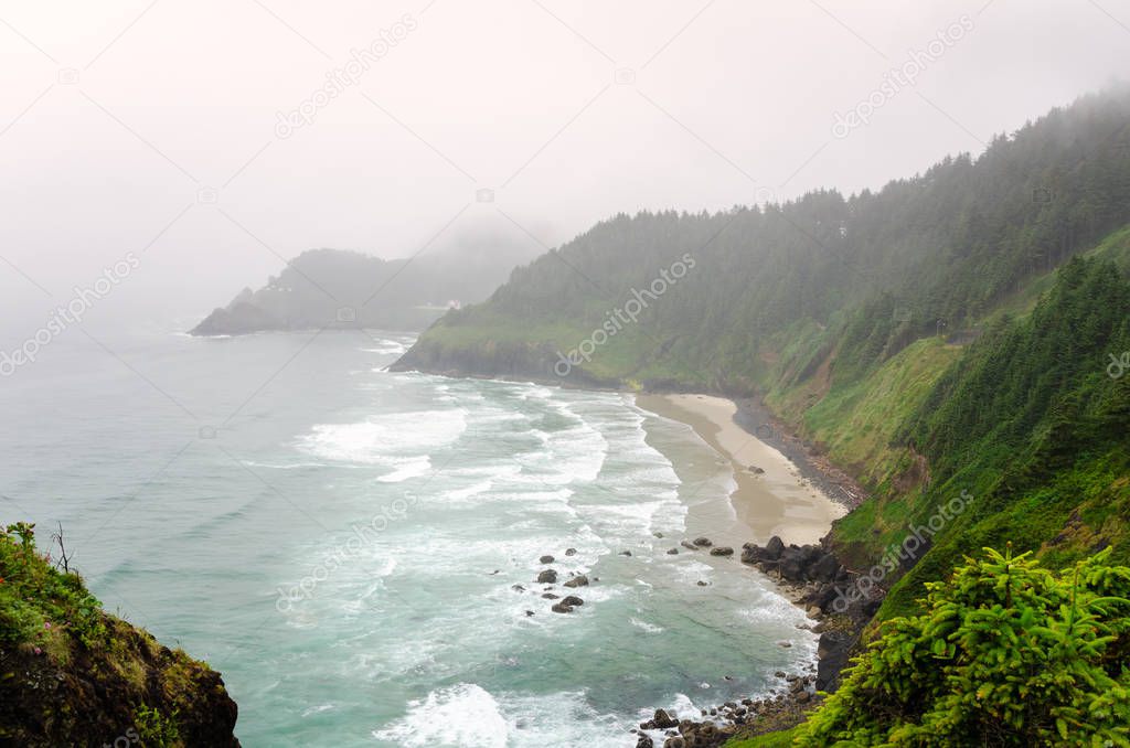View of a bay along the coast of Oregon on a foggy summer day