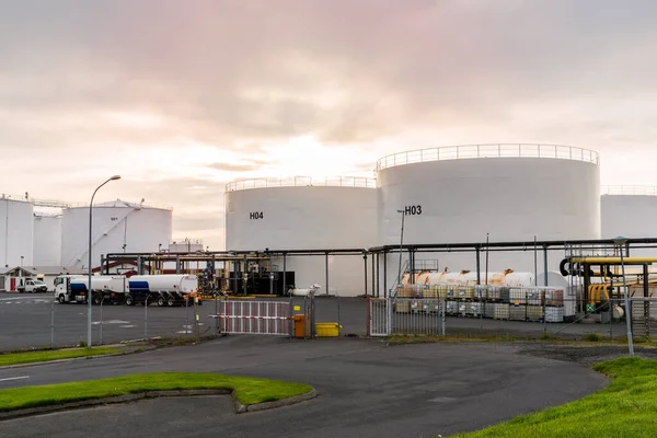 View of large fuel storage tanks in a commercial port at sunset. Reykjavik, Iceland.