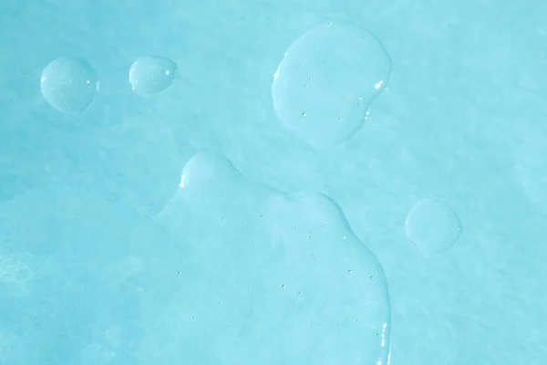 Close up photo of transparent drop of skin care product.