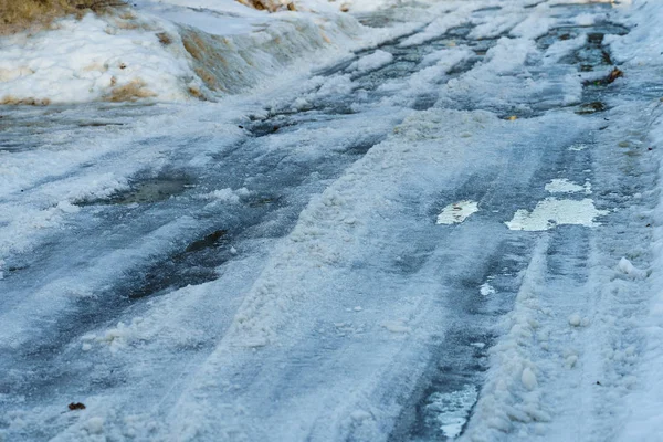 Straße mit Schnee und Eis mit Spurrillen bedeckt — Stockfoto