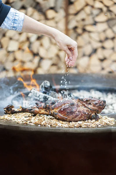Woman cooking and salting meat on grill — Stock Image Woman Cooking Salting Meat Grill Stock Image