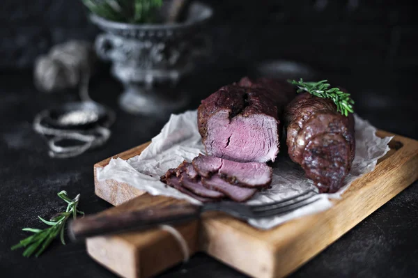 Close Photo Tasty Grilled Meat Rosemary Fork Wooden Board Blurred — Stock Photo, Image