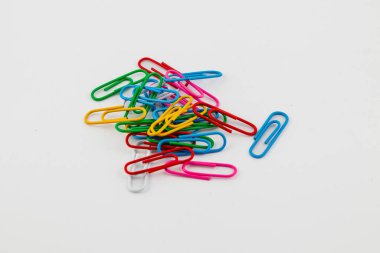 Değişik renklerde ataçlardan oluşan canlı bir koleksiyon temiz beyaz bir yüzeye yayılmış, organize bir kaosun içinde eşsiz şekillerini ve renklerini sergiliyor..