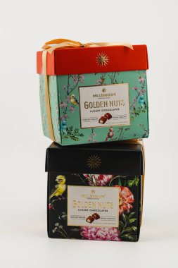 Ukraine Lviv 20.08.25Two beautifully designed luxury chocolate boxes are stacked together. One features a floral green design, while the other has a black background with colorful flowers.