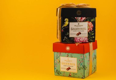 Ukraine Lviv 20.08.25Two beautifully designed chocolate gift boxes stacked on a vibrant yellow background showcase their rich contents, perfect for a celebration or special occasion.