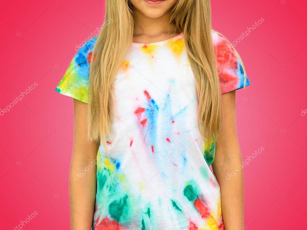 Girl in a t-shirt in the style of tie dye on a red background. White clothes painted by hand.