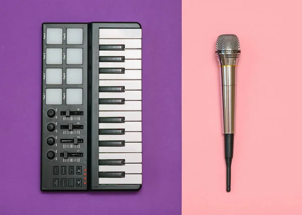 Electronic music mixer and radio microphone on two-tone background. Equipment for the music Studio. The view from the top. Flat lay.