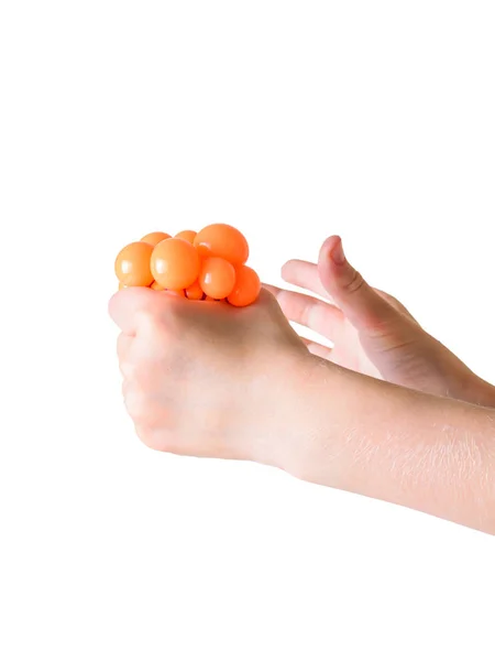 A criança aperta o brinquedo anti-stress mão isolado no fundo branco . — Fotografia de Stock