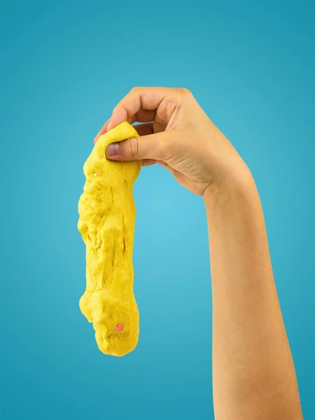 Yellow slime is derived from the child\'s hand on a blue background.