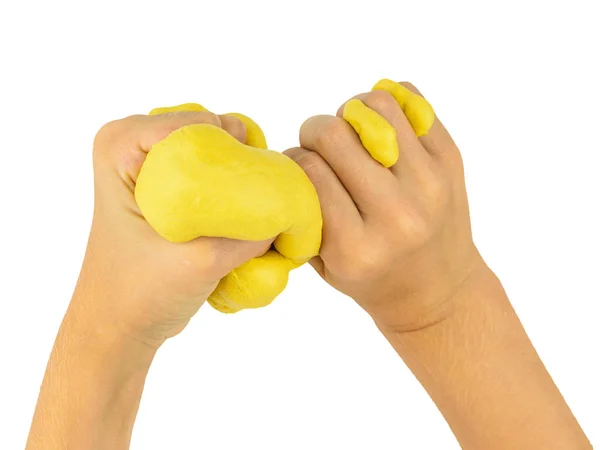 The child's hands squeeze the yellow lime isolated on a white background. — Stock Photo, Image