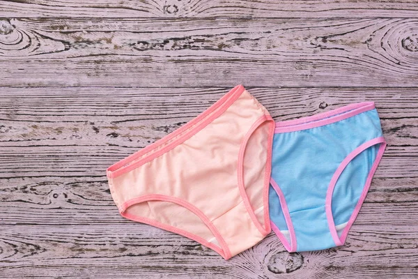 Pink women's panties on top of the blue on a pink wooden background. Fashionable concept. Beautiful lingerie. The view from the top. — Stock Photo, Image