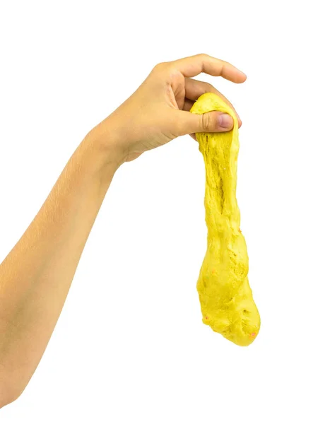 Grote druppel gele slayma komt voort uit de handen van het kind. — Stockfoto