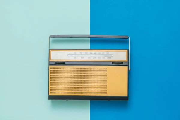 Vintage radio on a blue and light blue background. Vintage technique.