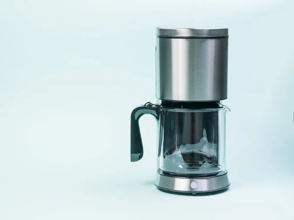 Silver drip coffee maker on a light blue background. — Stock Photo, Image