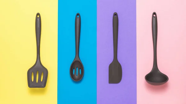 Set of silicone kitchen accessories on a colored background.