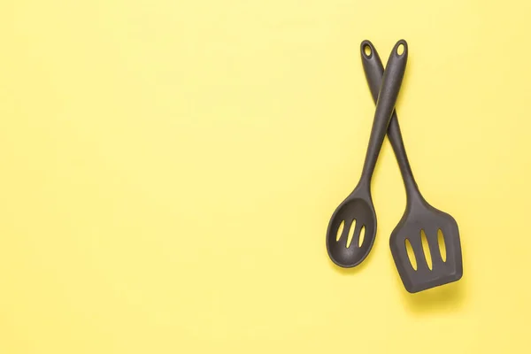Two tablespoons of a silicone device on a yellow background. — Stock Photo, Image