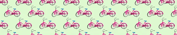 Seamless pattern of red bicycles on a light green background.