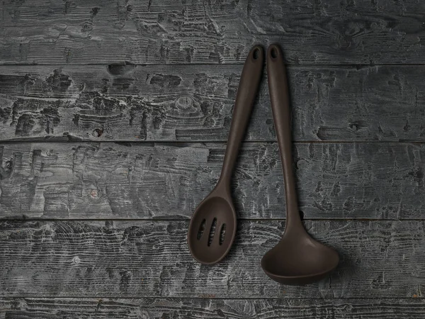 Silicone ladle and spoon on wooden background. — Stock Photo, Image