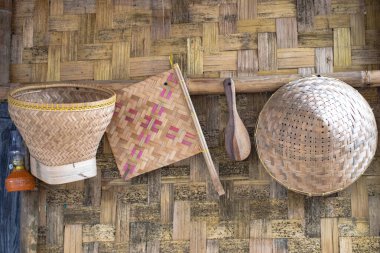 Background of rice harvest and traditional kitchen utensils.
