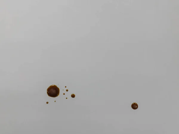 brown coffee drops on light gray table top