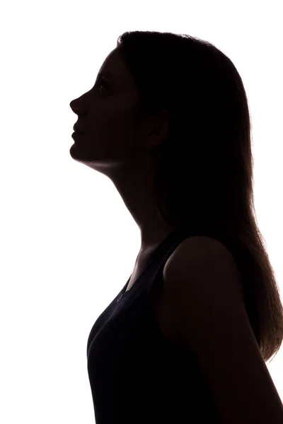 Jonge vrouw op zoek-verticaal silhouet — Stockfoto