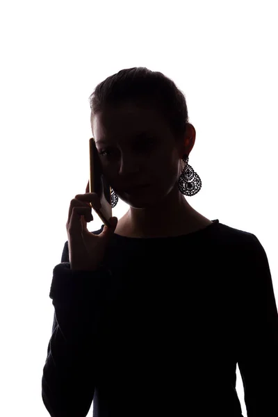 Mujer joven llamada telefónica - silueta —  Fotos de Stock