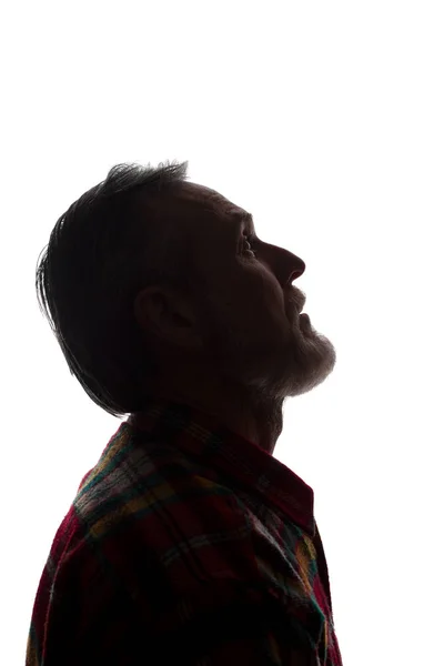 Yaşlı bir adamın portresi, yan görünüm-koyu izole siluet