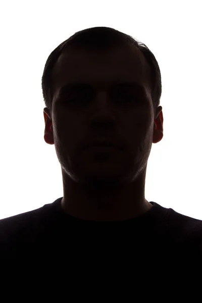Portret van een jonge man, vooraanzicht-donker geïsoleerd silhouet — Stockfoto