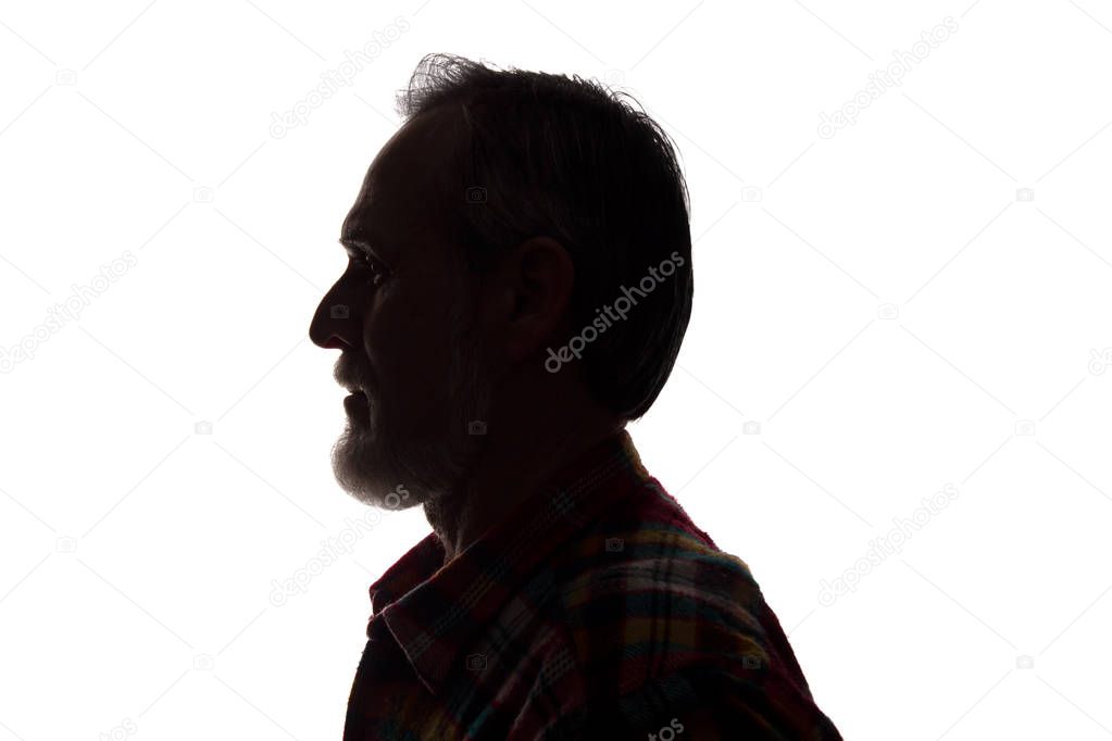 Portrait of a old man, side view - dark close-up silhouette