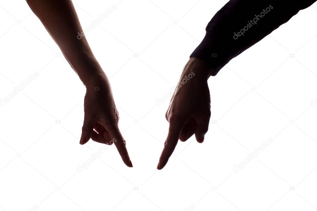 Female and male hands pointing down - silhouette