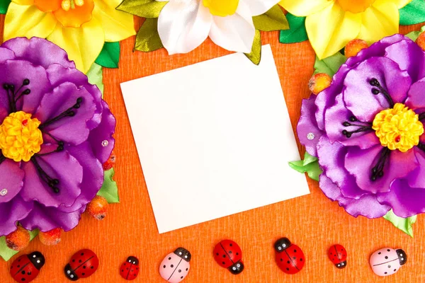 Frame of bright artificial flowers and ladybirds - a multi-colored, background — Stock Photo, Image