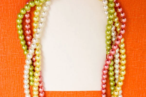 Bright multi-colored beads with a blank sheet of paper - frame, background — Stock Photo, Image
