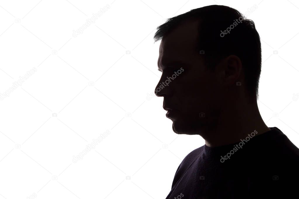 Portrait of a young man, side view - dark isolated silhouette